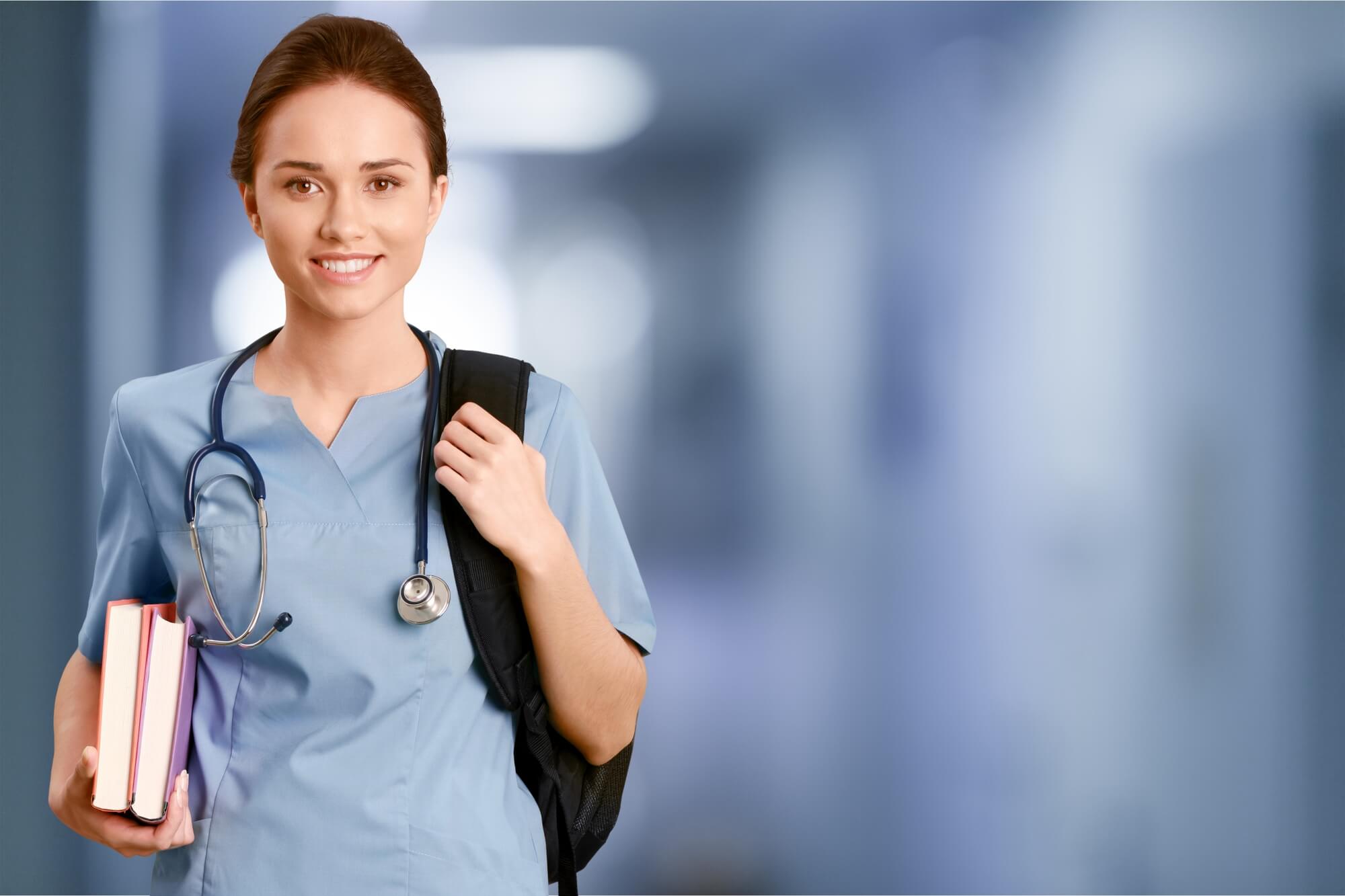 Smiling young nurse with backpack