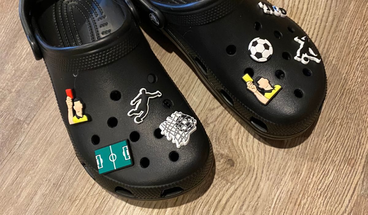 black croc clogs with soccer sport charms